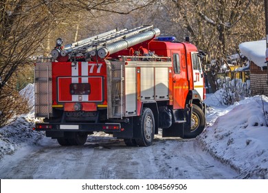 Russia. The Red Fire Truck Is Moving To The Fire In The Yards. Winter. Snow.