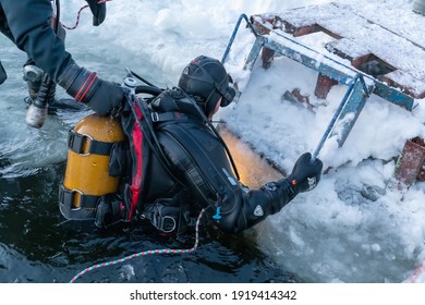 Russia, River Volga Kama - Jan 17th 2020. Diver before scuba ice diving. Outdoor Winter diving underwater in professional diving equipment preparing to ice dive