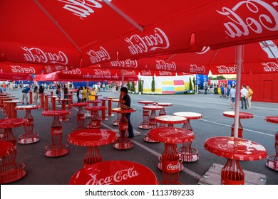 Russia, Rostov-on-Don, June 15, 2018: FIFA World Cup 2018 zone Coca-Cola with branded tables and umbrellas in Rostov-on-Don, where they eat and drink football fans
