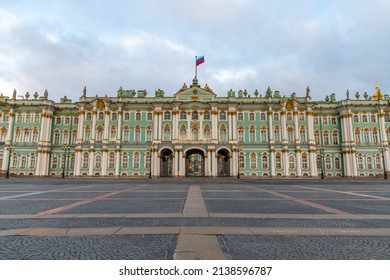 Russia, Saint Petersburg - February 26, 2022: Winter Palace Of The State Hermitage Museum In Saint Petersburg City In The Early Morning. No People. The Russian Flag Flutters In The Wind.