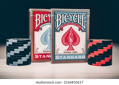 Russia, Saint-Petersburg, 12 June 2022: Two Old Deck Of Bicycle Playing Cards Standart And Poker Chips On A White Wooden Background. 