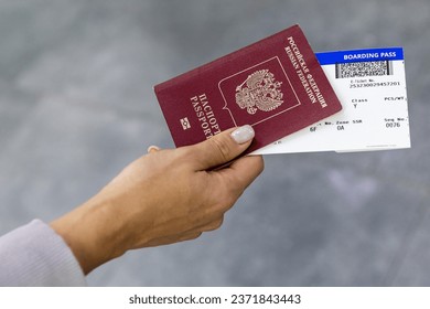 Russia. Saint-Petersburg. The passenger holds a Russian passport and boarding pass. Translation: Passport of the Russian Federation