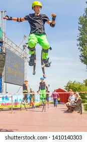 Russia, Samara, August, 2018: a young man jumps on jumpers on the Volga River Embankment on a summer sunny day