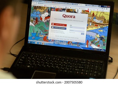 Russia, Samara, July 2020: A young man during the coronavirus epidemic watches the Quora website at night on a laptop.