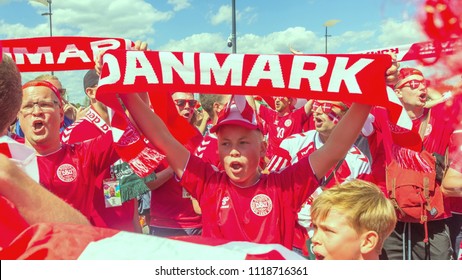 Russia, Samara, June 2018: Decorated Football Fans With The Flag On Face From Denmark At The World Cup.