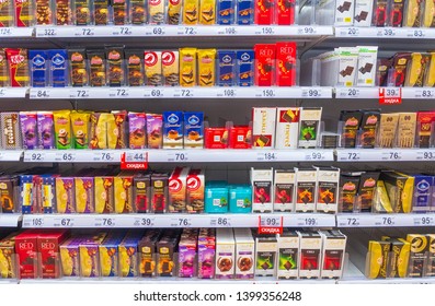 Russia, Samara, May 2019: A large selection of chocolate on the supermarket shelves. Text in Russian: discount
