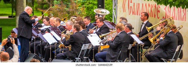 Russia Samara May 2019: A Large Orchestra Plays Music In A City Park On A Summer Day.