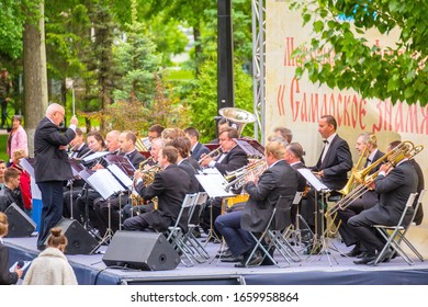 Russia Samara May 2019: A Large Orchestra Plays Music In A City Park On A Summer Day.