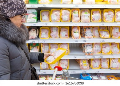 Russia Samara November 2019: A Woman Holds In Her Hand A Package Of Chicken Meat In The Semi-finished Department In The Store.