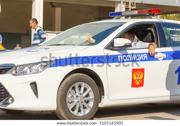 Russia,\
Samara, September 2017: Russian police patrol car, on a city street\
on a summer day. The text in Russian:\
police.