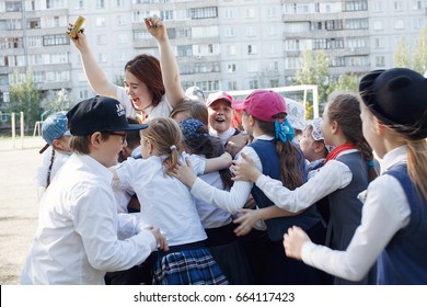 Russia. Siberia. May 2017. Elementary school students in the Park hugging teacher