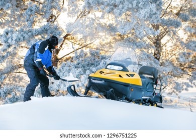 Russia, Sibiria, January 24, 2019: Man With Stuck Snowmobile. Sunrise, Sunset Winter Day. Winter Fun For Man.