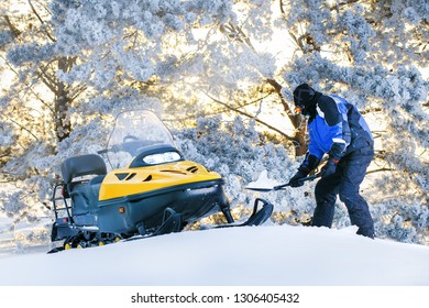 Russia, Sibiria, January 24, 2019: Man With Stuck Snowmobile. Sunrise, Sunset Winter Day. Winter Fun For Man.