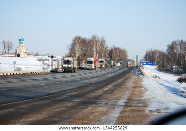 Russia. Smolensk region. February 1, 2012. Auto\
trucks length gages go on Minskoye Highway in the winter clear\
morning. Business on transportation of goods on highways of the\
country.