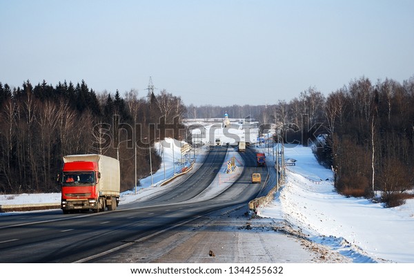Russia. Smolensk region. February 1, 2012. Auto\
trucks length gages go on Minskoye Highway in the winter clear\
morning. Business on transportation of goods on highways of the\
country.