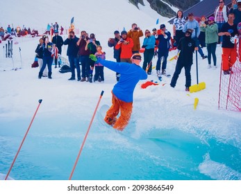 Russia, Sochi 11.05.2019. A Guy Snowboarder Drove The Pool To The End And At The Finish I Photograph Him. Krasnaya Polyana