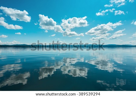 Russia. The Southern Urals. Lake Turgoyak.
Clouds reflected on the water surface of the lake in clear weather.
