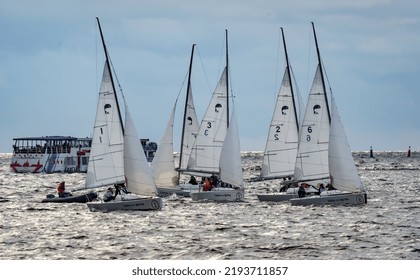 Russia, St. Petersburg, 29 July 2022: Few Small Sport Sailing Boats At Sunset With Stormy Sky, Sailing Regatta, Teamwork, Hot Pursuit