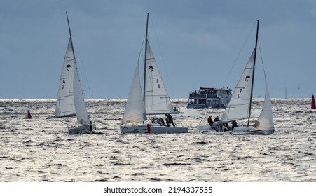 Russia, St. Petersburg, 29 July 2022: Few Small Sport Sailing Boats At Sunset With Stormy Sky, Sailing Regatta, Teamwork, Hot Pursuit