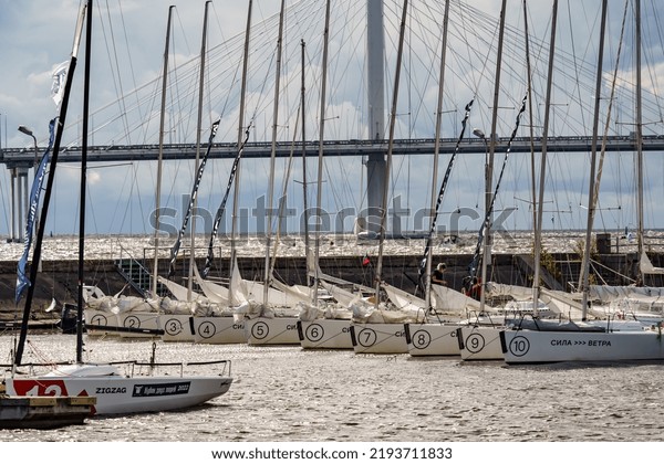 Russia, St.
Petersburg, 29 July 2022: The embankment of the central yacht club
at cloudy weather, piers in marina, small sports sailing boats,
Cable-stayed bridge on
background