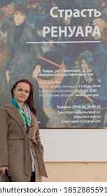 Russia, Tver 10/01/2020 A Woman Stands Near The Poster Of The Exhibition Of Paintings By Pierre Auguste Renoir