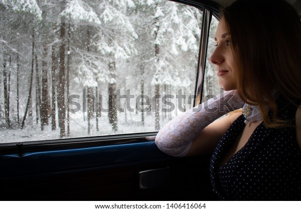Russia, Ural, Sverdlovsk region, 21.04.2019\
Suddenly the April sun went out and snow fell in mid-April. \
And a\
beautiful Russian girl went for a walk. She walks through the\
woods, makes snowballs.