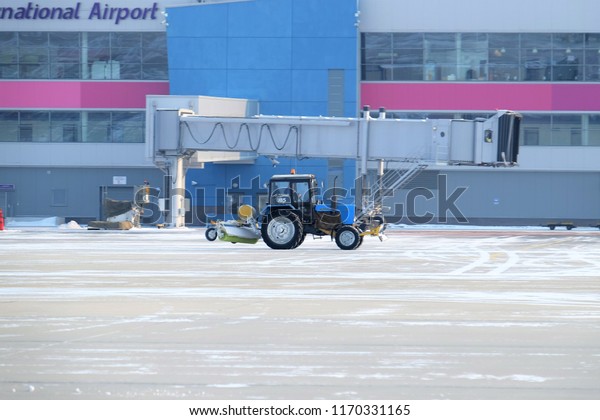 Russia, Vladivostok, 02/08/2016.\
Clearing airport from snow during snow storm. clearing runway from\
snow. Clearing snow with bulldozers from airport\
aprons.