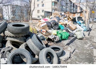 Russia, Vladivostok, 03/23/2020. Garbage Dump In Residential Area. Dirt And Stench, Environmental Issues. Mud In The Streets. City Infrastructure And Its Problems. Bad Quality Of Life.