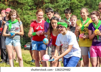 RUSSIA, YAROSLAVL - 30 JUN 2012: Group Happy Children And Adult Teens Relax In Summer Forest Tent Camp Play Active Games On Banks Volga River Participate In Competitions On Bright Sunny Day