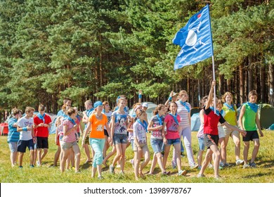 RUSSIA, YAROSLAVL - 30 JUN 2012: Group Happy Children And Adult Teens Relax In Summer Forest Tent Camp Play Active Games On Banks Volga River Participate In Competitions On Bright Sunny Day