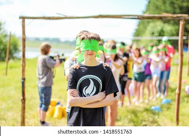 RUSSIA, YAROSLAVL - 30 JUN 2012: Group Happy Children And Adult Teens Relax In Summer Forest Tent Camp Play Active Games On Banks Volga River Participate In Competitions On Bright Sunny Day