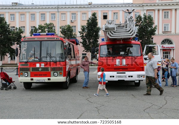 RUSSIA, YOSHKAR-OLA, AUGUST 5, 2017: Fire truck\
and bus at the Exhibition of military and rescue vehicles on the\
city\'s central square