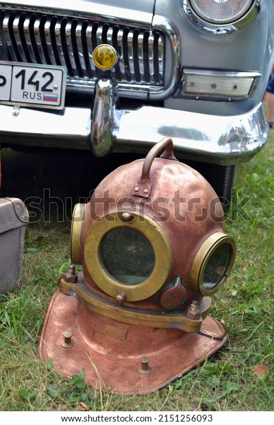 RUSSIA-KEMEROVO, 2019: Diving helmet on the\
background of the Volga\
car