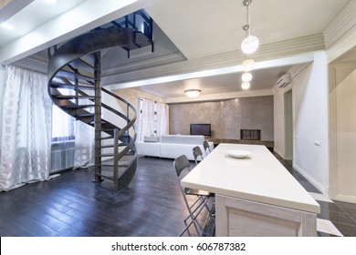 Russia,Moscow - modern living room interior. Duplex apartment with a stylish spiral staircase.