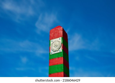 Russian Border Post With Coat Of Arms Against A Blue Cloudy Sky