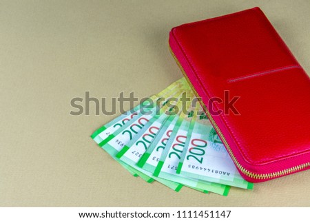 Russian cash. Banknotes in two hundred rubles. Red woman wallet. Payment