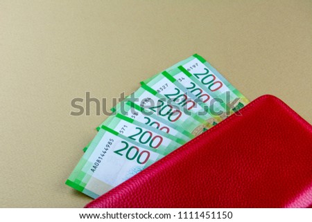 Russian cash. Banknotes in two hundred rubles. Red woman wallet. Payment