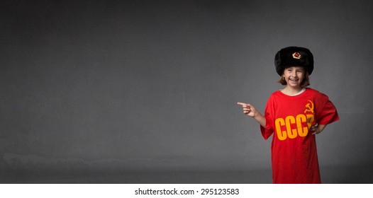 russian child indicated empty space, dark background