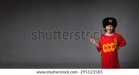 russian child indicated empty space, dark background