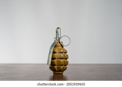 RUSSIAN COMBAT HAND GRENADE F-1 STANDING ON A TABLE. UZRGM-2 82 UZPCH means that the explosive device uses the UZRGM-2 fuse.