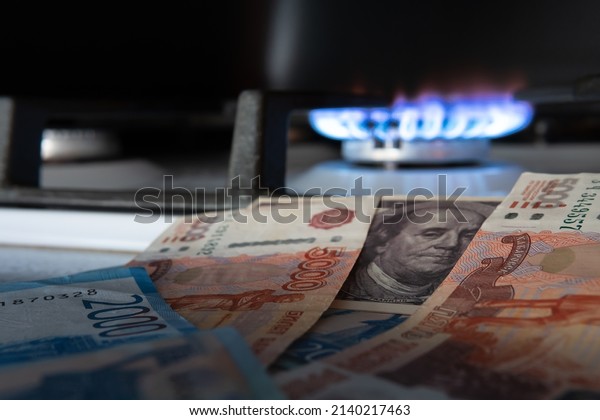 Russian currency on the background of the dollar
and burning gas.The concept of gas and oil payment in Russian
currency.Selective
focus.