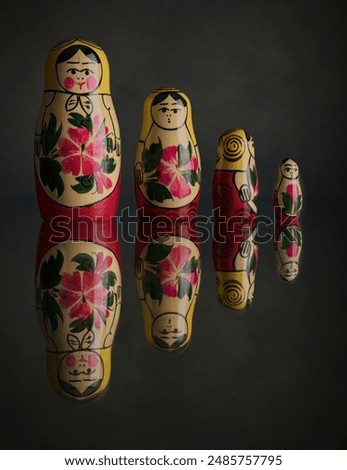 Russian Dolls Reflected in a shiny surface