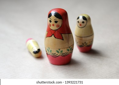 Russian dolls - wooden nesting dolls Matryoshka Babushka, vintage toys hand painted by unknown artisans with folk traditional feel. Little girl is lost and frightened and big dolls broken in pieces.
