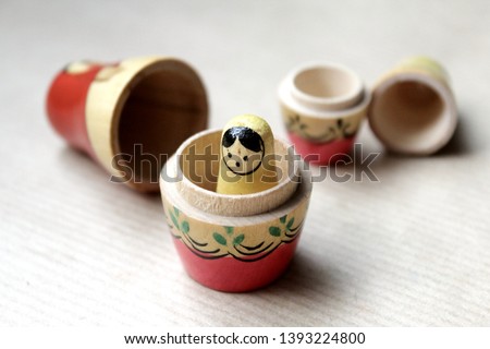 Russian dolls - wooden nesting dolls Matryoshka Babushka, vintage toys hand painted by unknown artisans with folk traditional feel. Little girl is lost and frightened and big dolls broken in pieces.