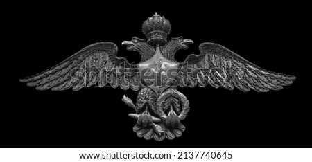 Russian double-headed coat of arms eagle, made from triggers, spherical bullets, and lock planks from flintlocks isolated on black background with clipping path