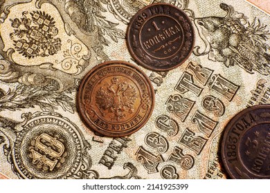 Russian Empire coins and vintage paper 10 rubles money note of 19th cent. Top view of old copper coins of Russia. Concept of antique currency, historical rare banknote, coat of arms and numismatics.