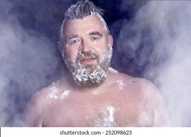 Russian Extreme: A Naked Man In The Snow With Frozen Beard And Hair In The Clouds Of Steam