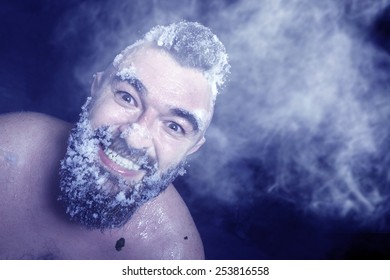 Russian Extreme: A Naked Man In The Snow With Frozen Beard And Hair In The Clouds Of Steam