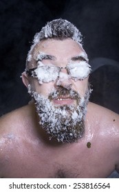 Russian Extreme: A Naked Man In The Snow With Frozen Beard And Hair In The Clouds Of Steam