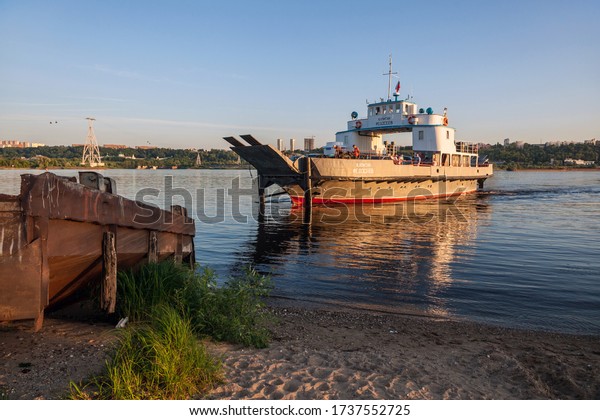 Russian Federation, Nizhny Novgorod, June 11,\
2019, On the Volga river, the ferry docks at sunset. Text: Ticket\
Office, Captain\
Fedoseyev.